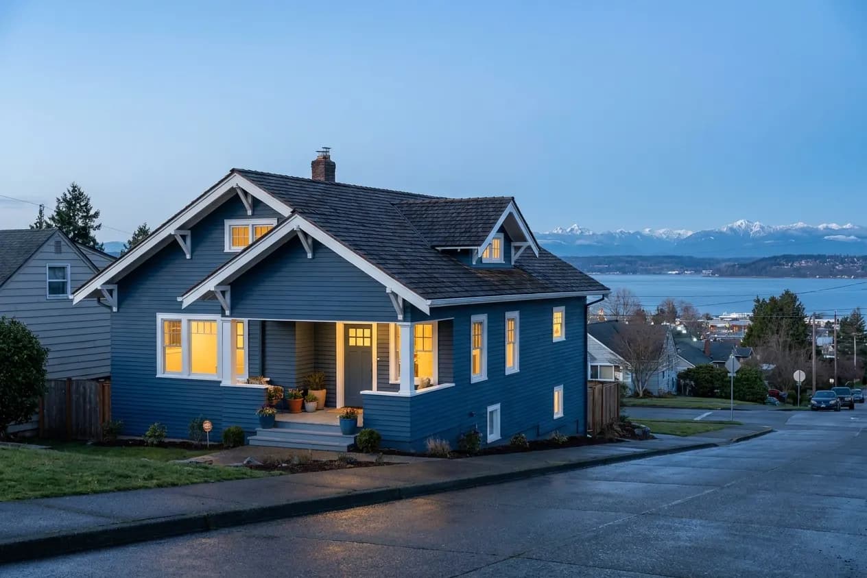 A restored blue Craftsman bungalow on a north Everett hillside above Port Gardner Bay