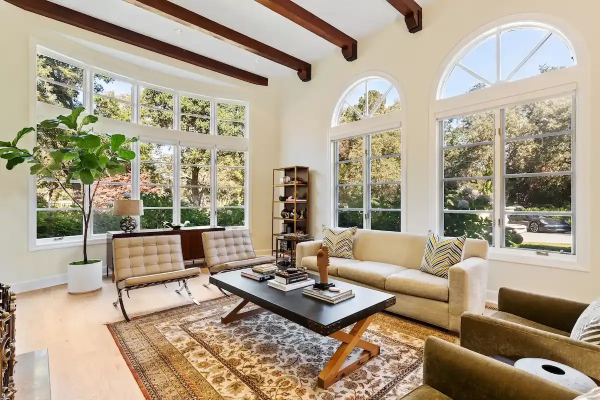 Living room with arched windows and wood beams, remodel, Atherton