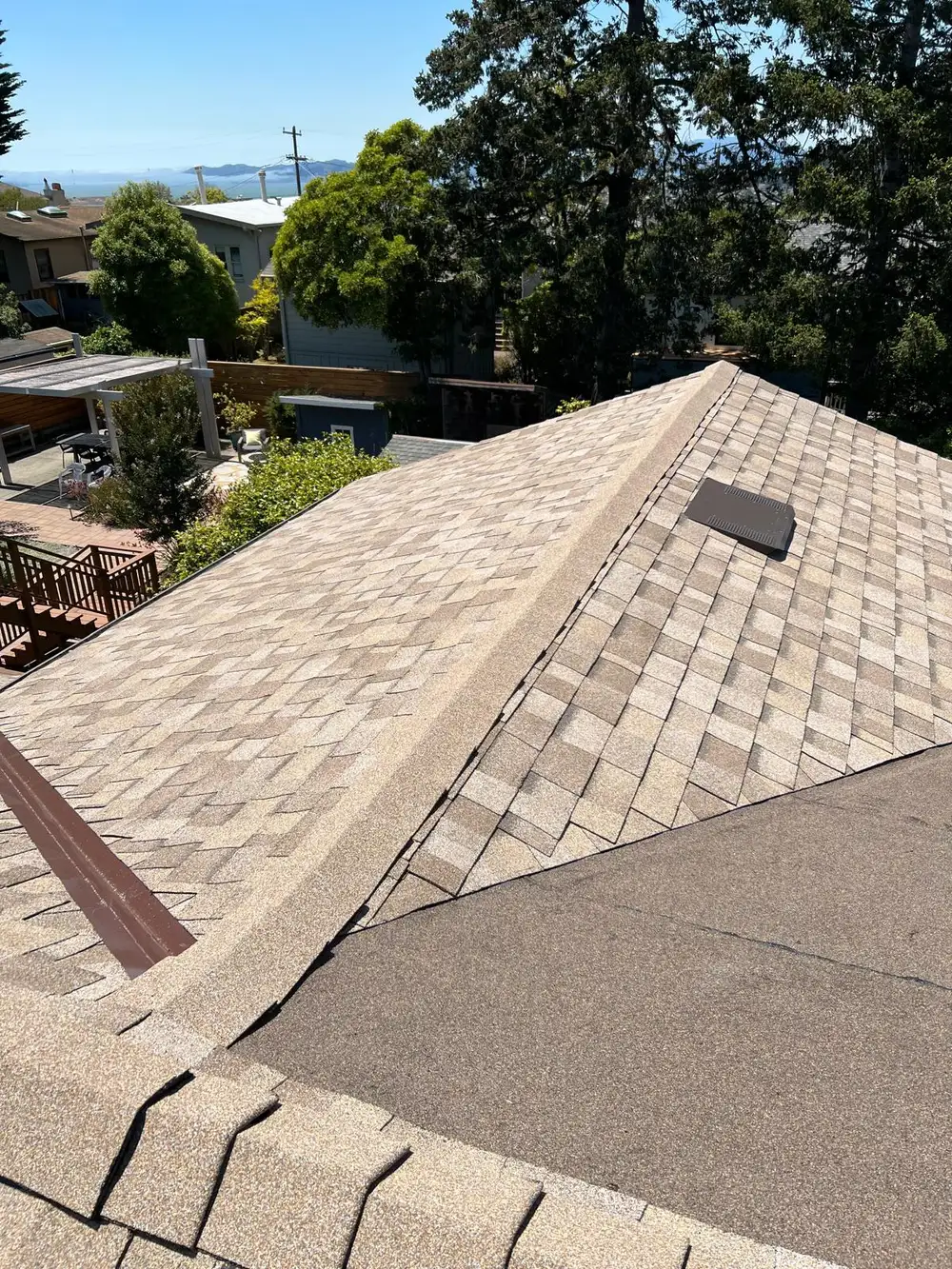 Asphalt shingle roof with ridge cap and roof vent