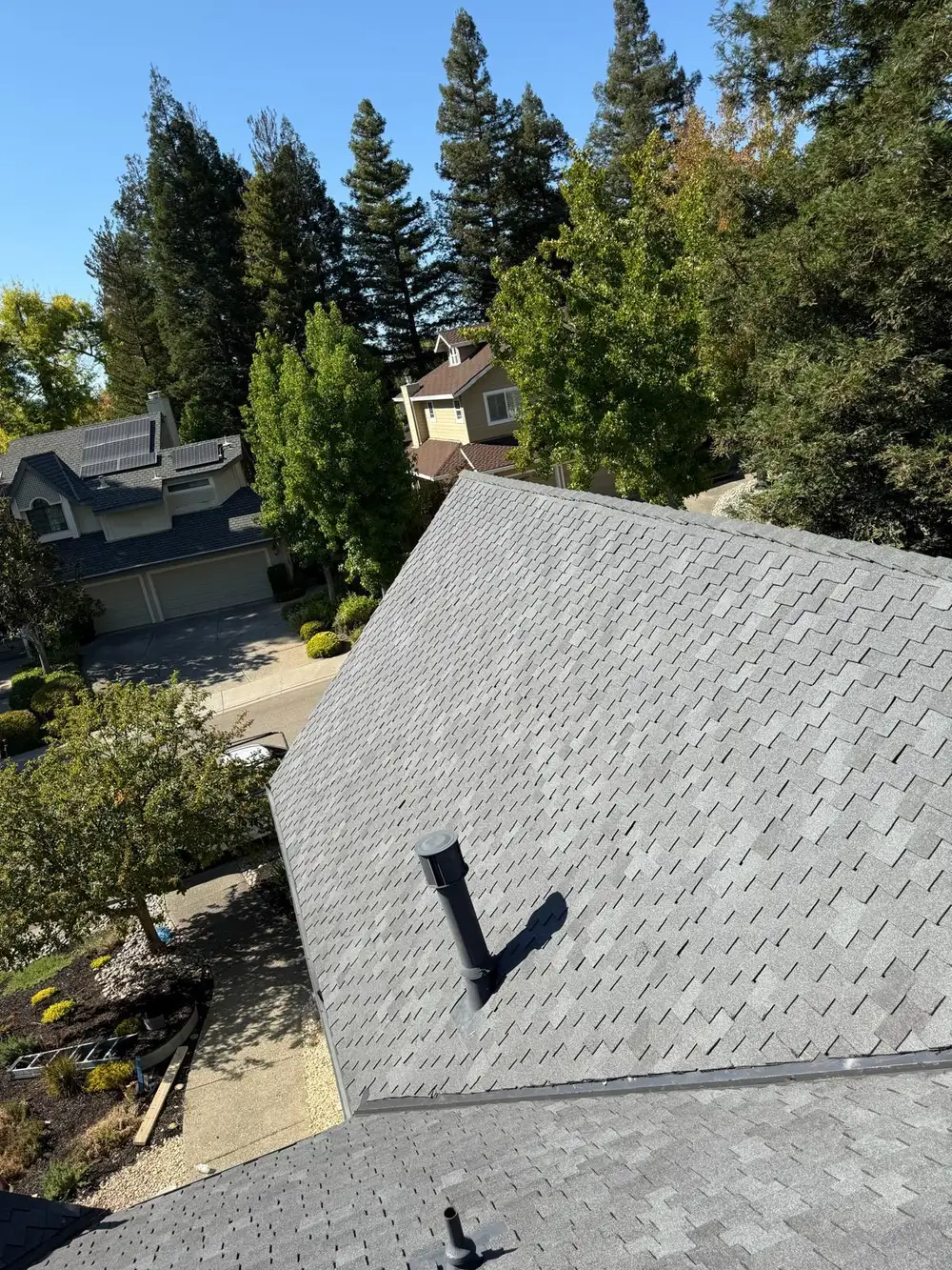 Gray asphalt shingle roof with flashed vent pipe