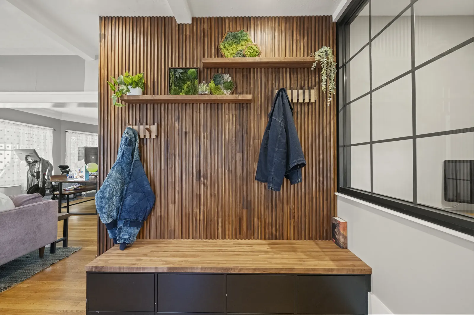 Custom wood-slat entry with built-in bench, Alameda whole-home renovation