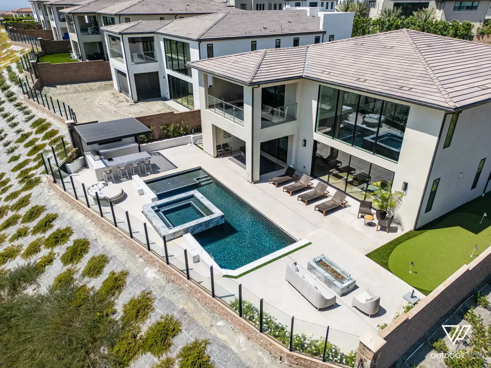 Hillside pool with raised spa, outdoor kitchen, fire feature and putting green, Porter Ranch