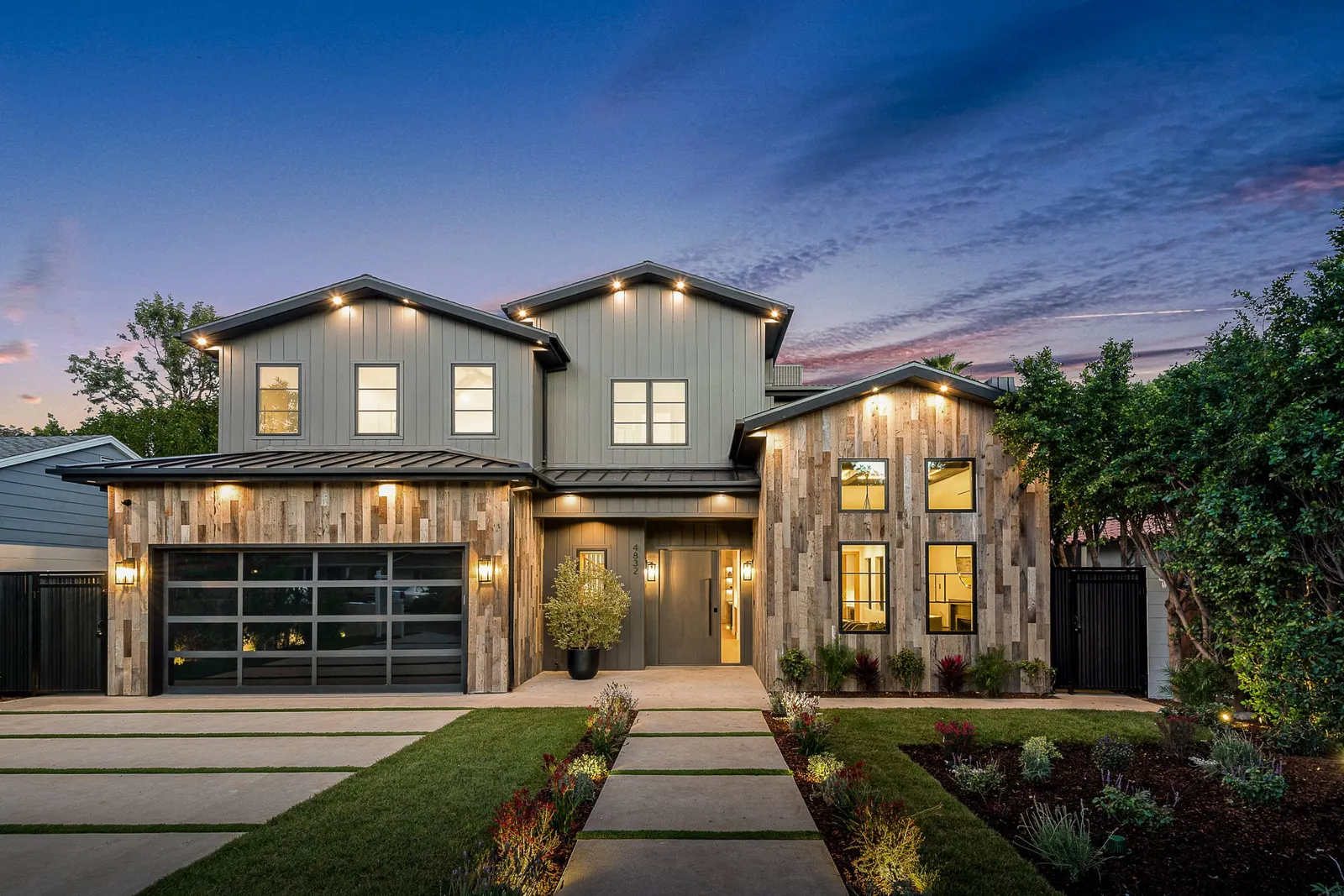 Front of a new two-story house with wood-look siding