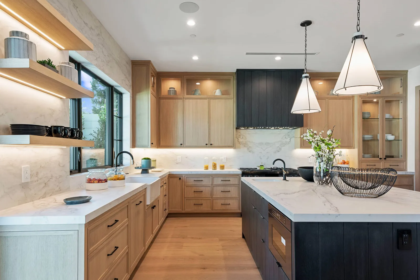 Kitchen with white oak cabinetry, open shelves and a dark island