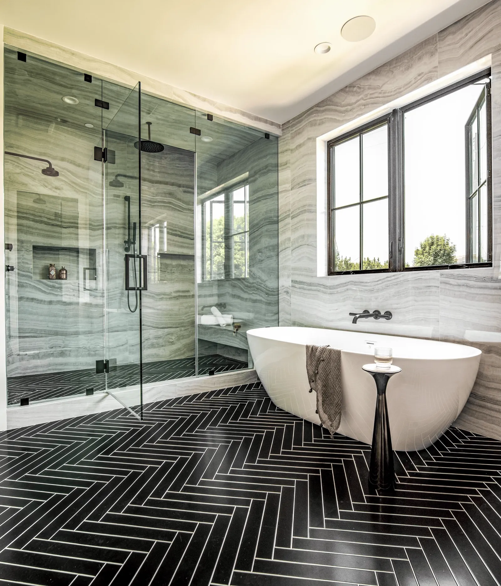 Primary bathroom with a freestanding tub and a glass steam shower