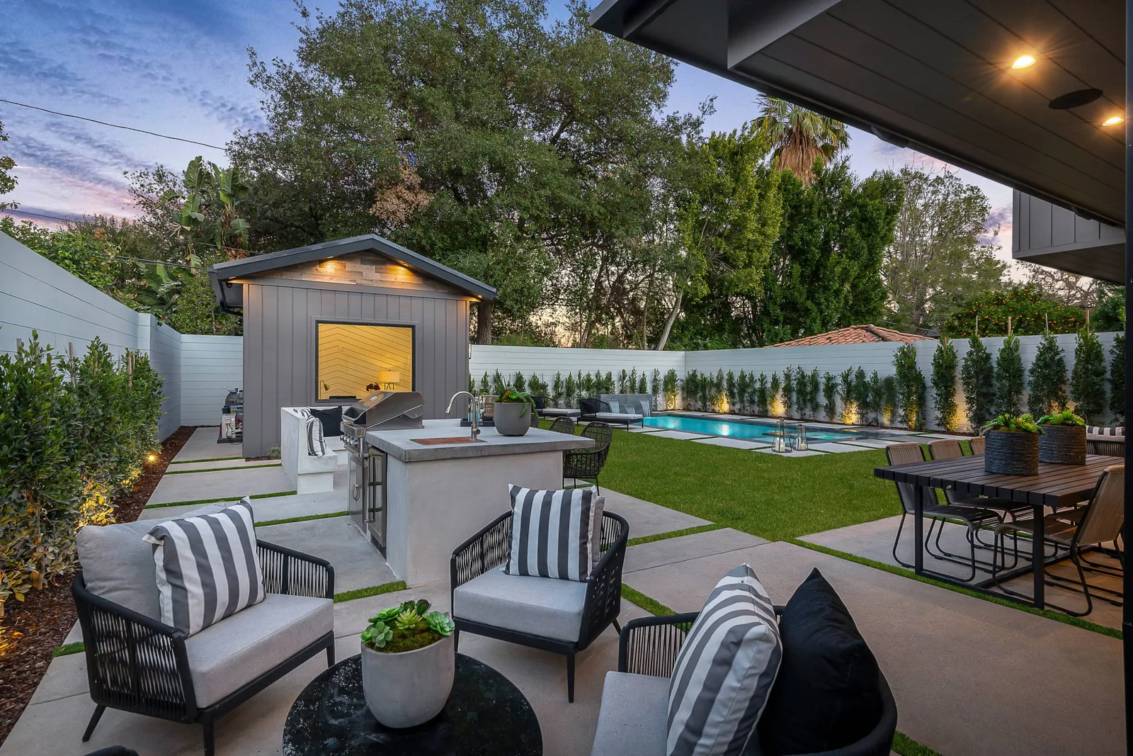 Covered patio and outdoor kitchen facing the pool