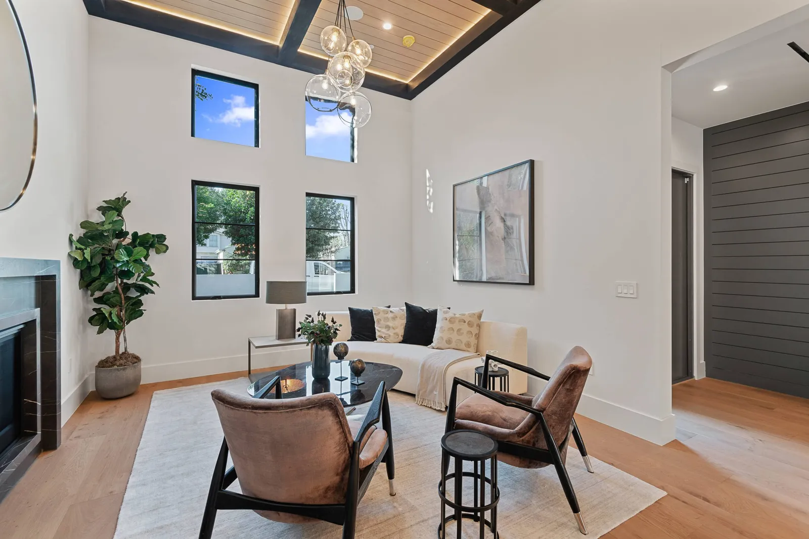 Living room with a fireplace under a double-height ceiling
