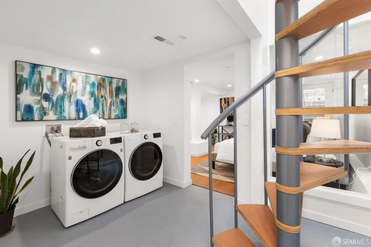 Portola ADU and garage conversion, laundry area with spiral staircase
