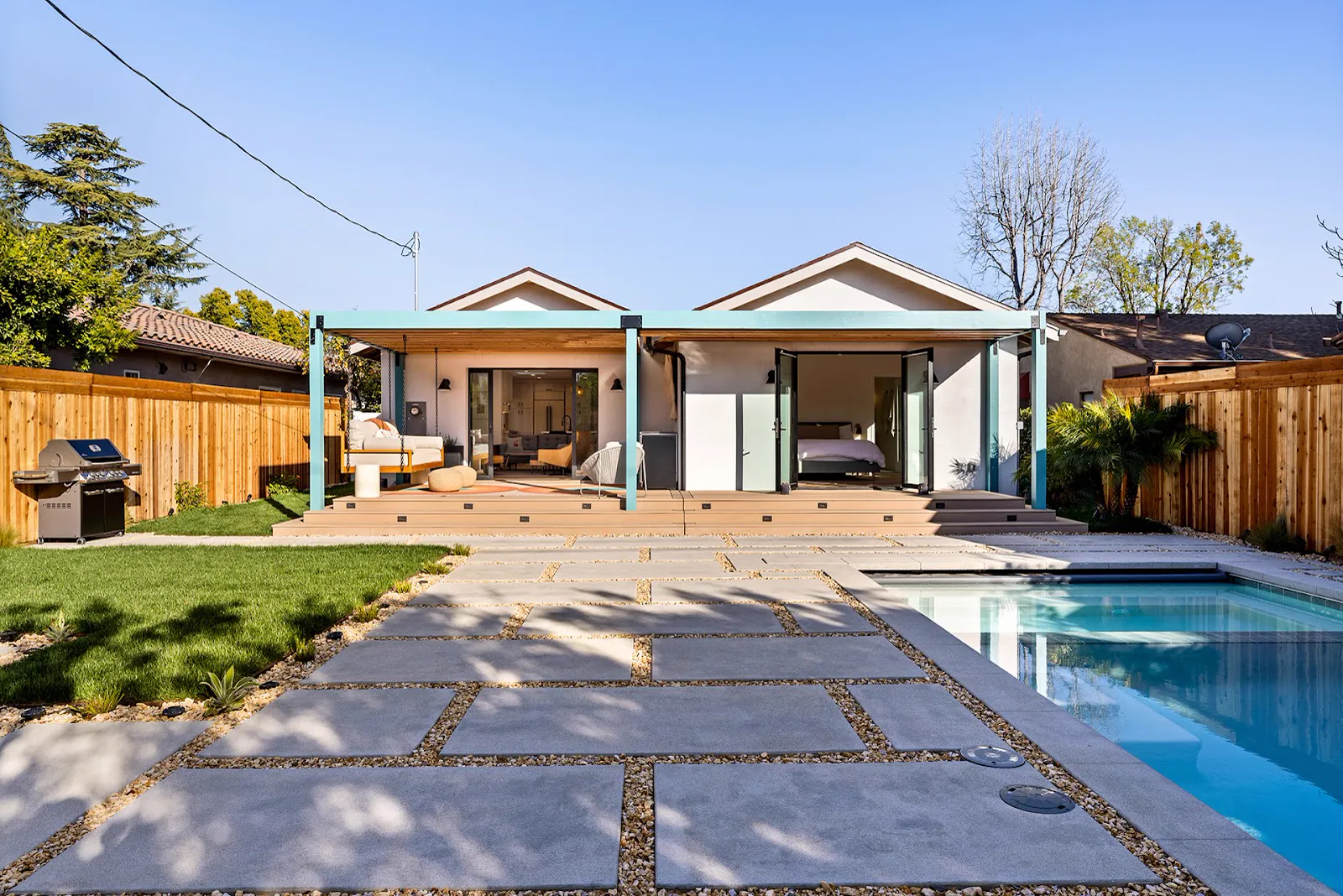 Full backyard remodel: pergola, new deck, pool and large-format paver hardscape