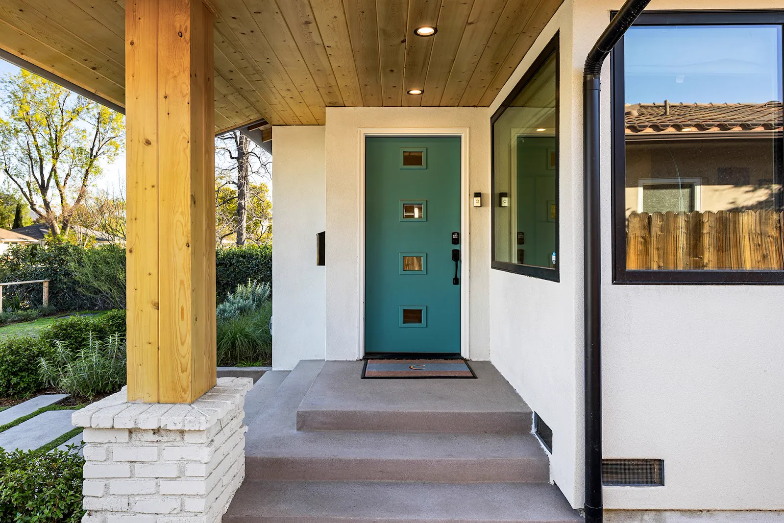 Remodeled front entry with mid-century door and cedar porch ceiling