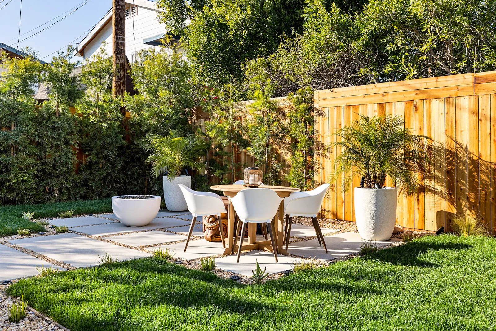 Backyard landscaping: cedar fence, pavers, fire bowl and fresh sod