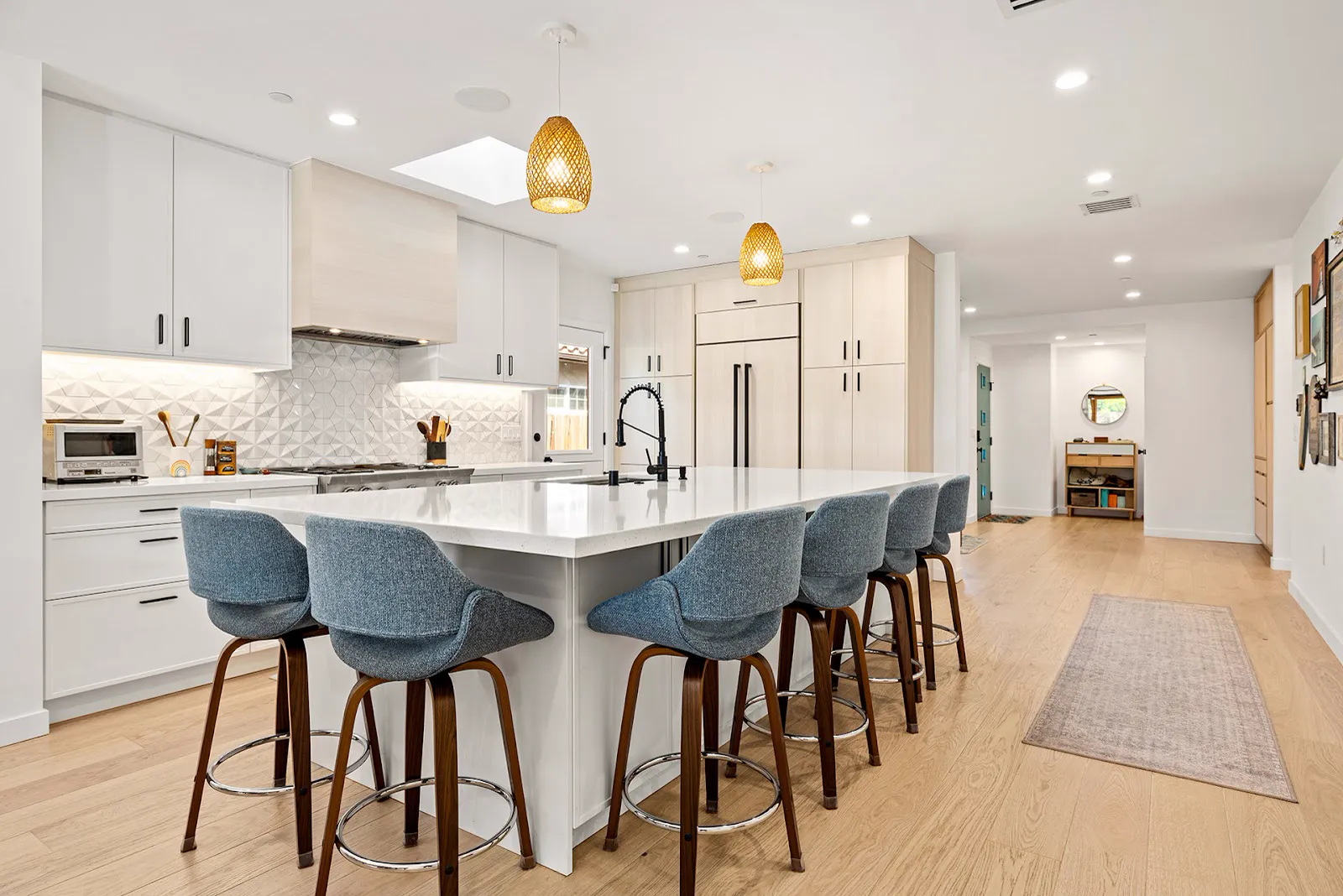 Kitchen with white quartz island and bleached-wood cabinetry